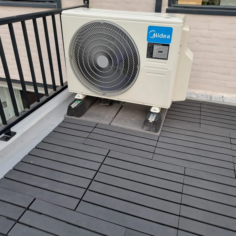 Buitenunit van een airco op een balkon